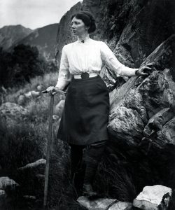 black and white portrait of du Faur on a mountainside, pickaxe in hand