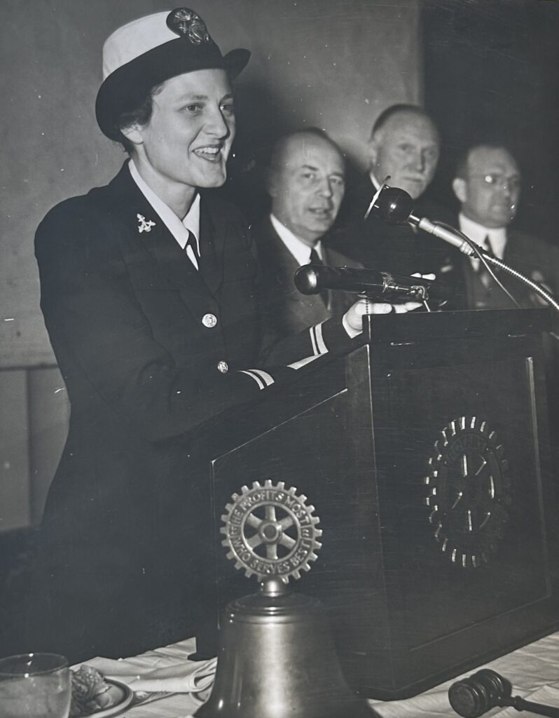 Black and white photograph of Frances in uniform speaking at a podium