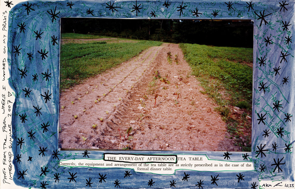 The page is covered in dark blue and in the center there is a photograph of a farm. Below the photo there is exposed text making up the poem, and on the left side of the page there is a handwritten description of the photograph.