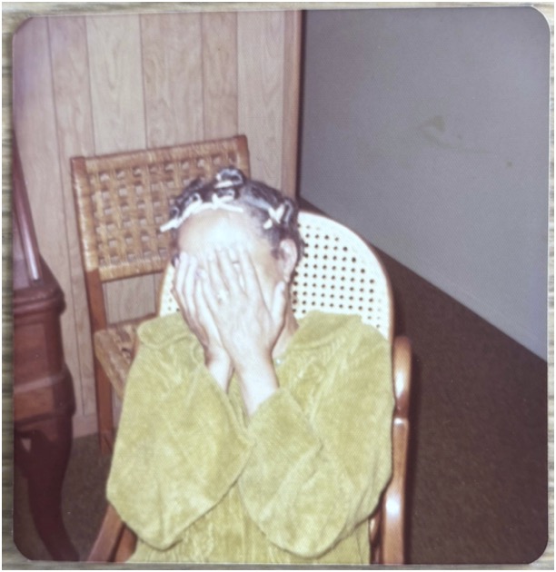 Color polaroid of Adelaide Cromwell hands covering her face. Date unknown.