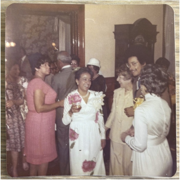 Color polaroid of Adelaide Cromwell with family and friends at her wedding reception to Philip H. Gulliver. Date: Unknown