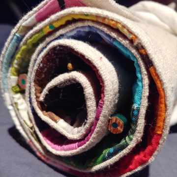 Fabric rolled into a spiral. Canvas on the outside, bright colors on the inside