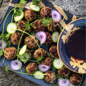 meatballs and star radishes with herb adornments and dipping sauce