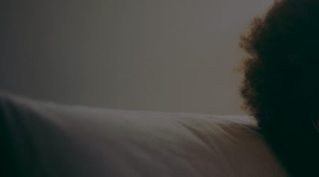 A head with an Afro on a pillow