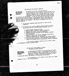 image of a microfilmed paper with the filmer's hand on the left side