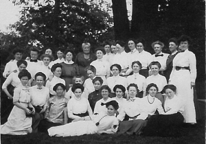 image of a group of women in white seated and standing.