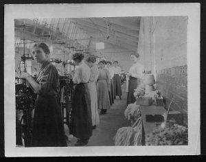 image of women working at machines in a textile factory