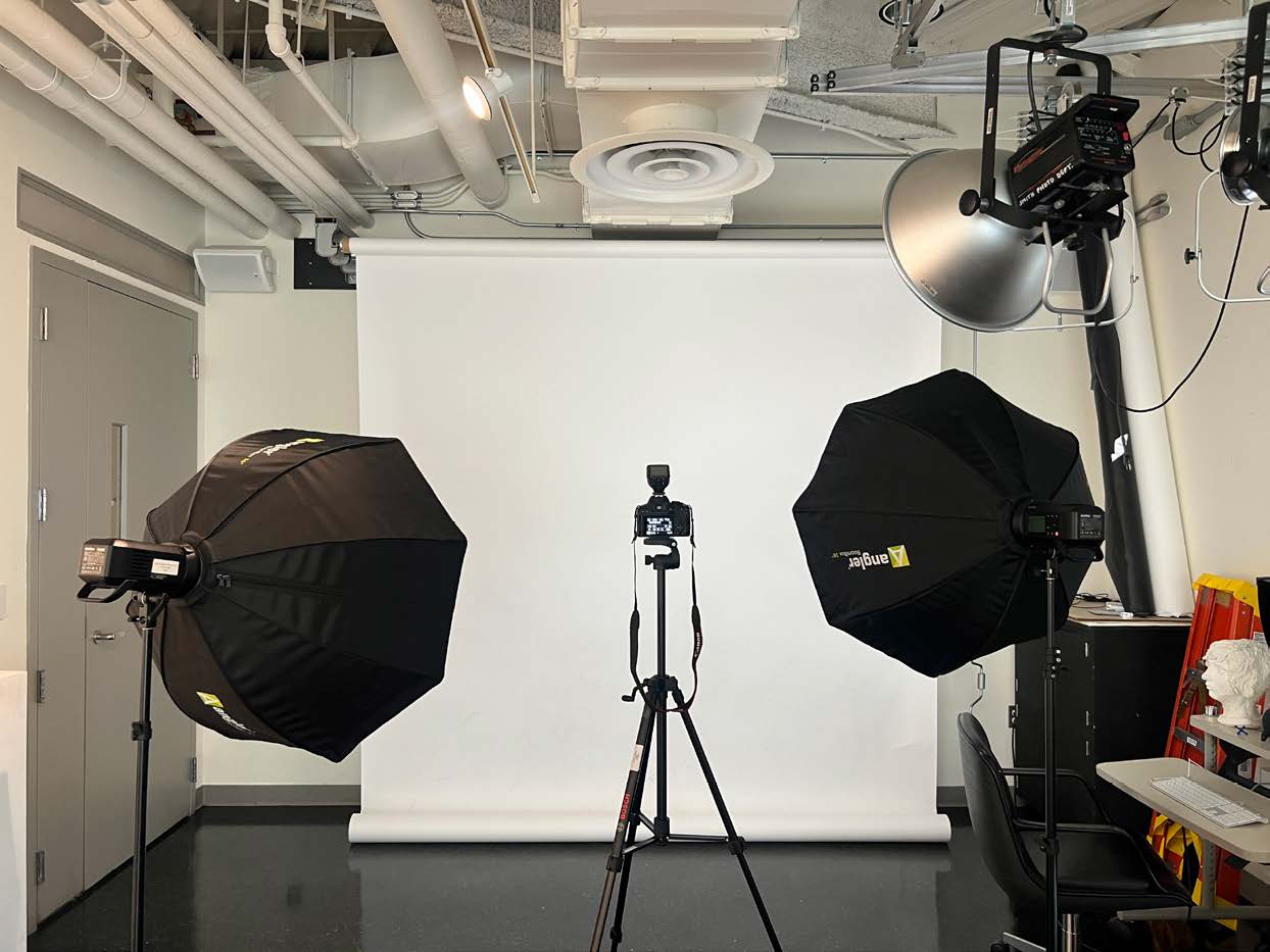 Figure 1: A standard strobe set up with 2 godox strobes set up behind the camera at 45 degree angles with attached softboxes. The camera is in the center on a tripod and has a wireless flash trigger attached.