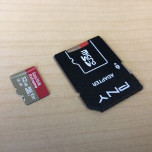 Two MicroSD cards, one with and one without a standard SD card-sized adapter