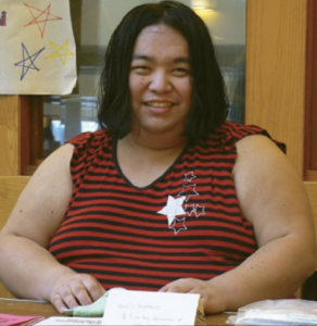 Author Emi Koyama wearing a striped shirt