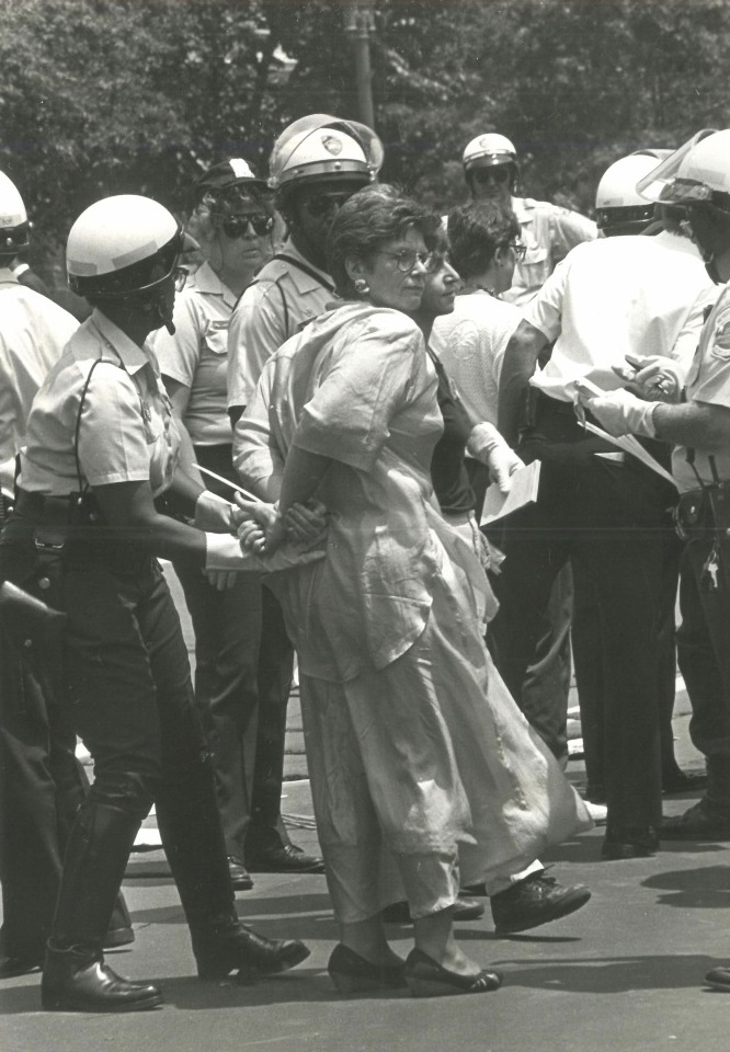 Virginia Apuzzo being arrested by police officers at the White House