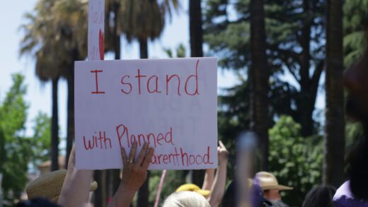 A group of people holding signs in support of Planned Parenthood.