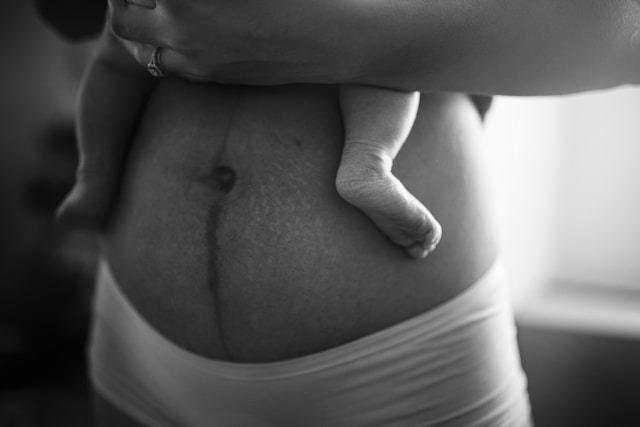 Black and white image of woman holding baby