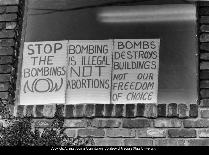 Photograph of anti-violence signs in the window of the Feminist Women's Health Center, Atlanta, Georgia, January 20, 1985.