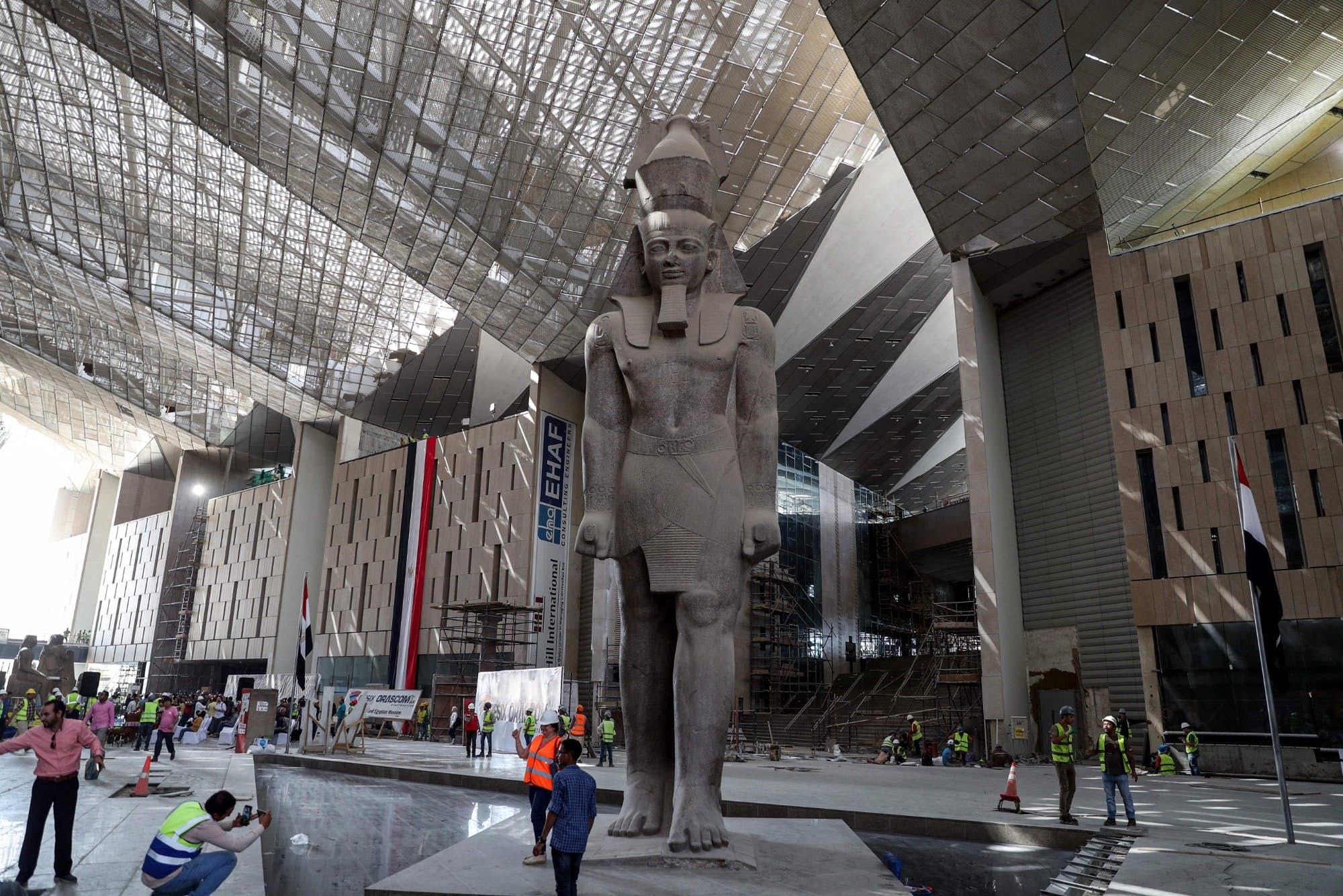 An image of the main hall of the Grand Egyptian Museum, housing a massive monument to Ramesses II.