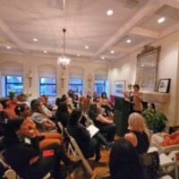 Ginetta E. B, Candelario ’90 addressing event attendees