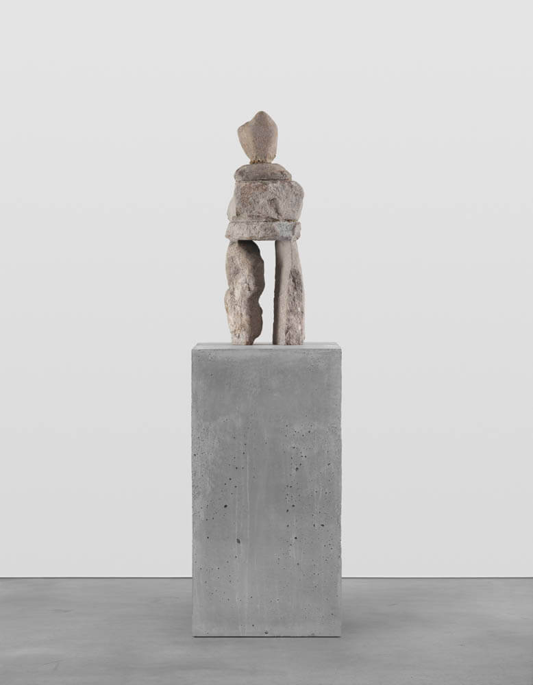 Stone humanoid statue entitled, "The Certain"