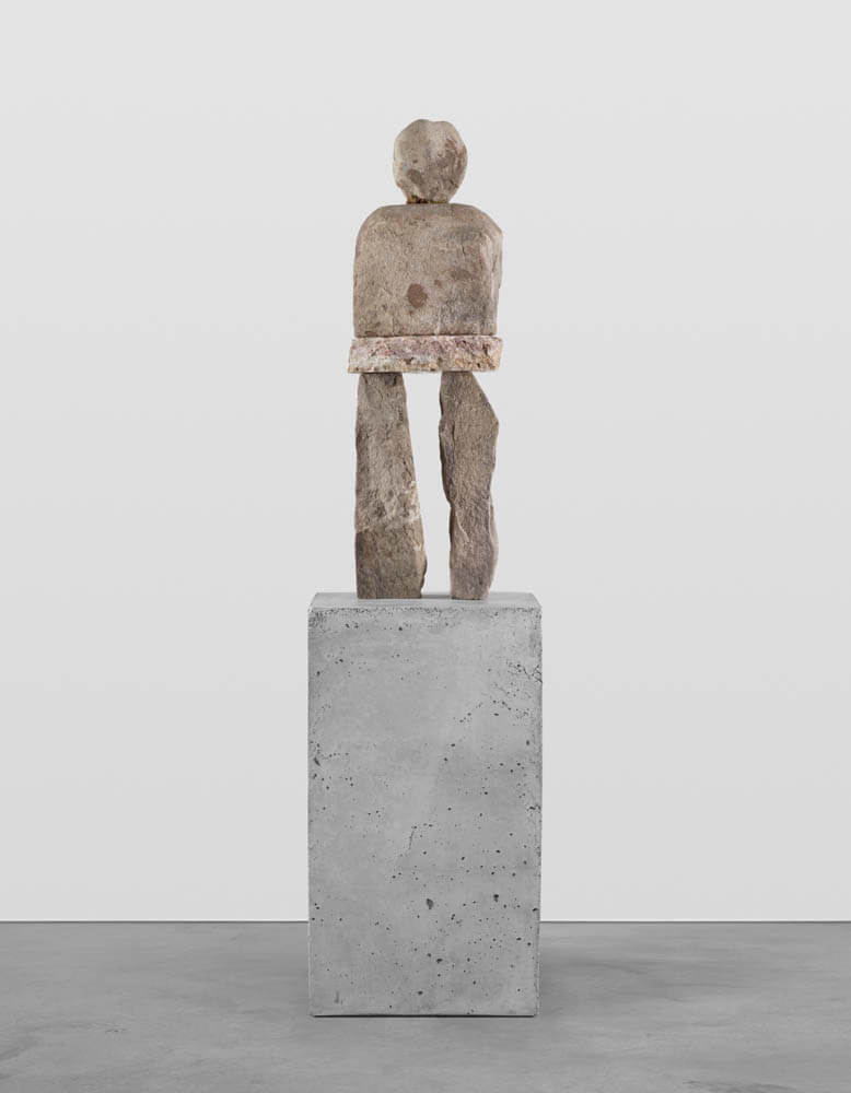 Stone humanoid statue entitled, "The Affected"