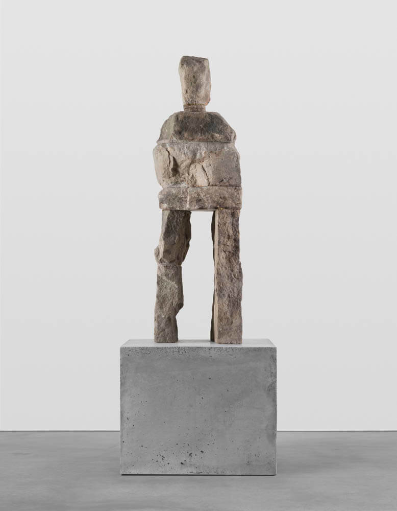 Stone humanoid statue entitled, "The Keen"