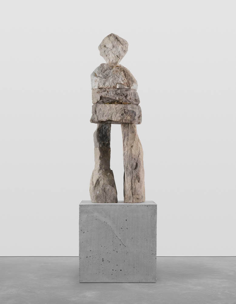 Stone humanoid statue entitled, "The Affectionate"