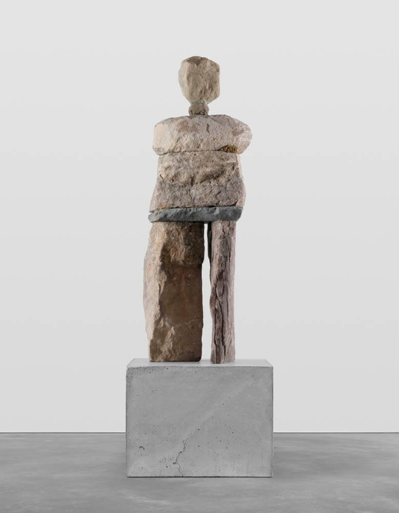 Stone humanoid statue entitled, "The Earnest"