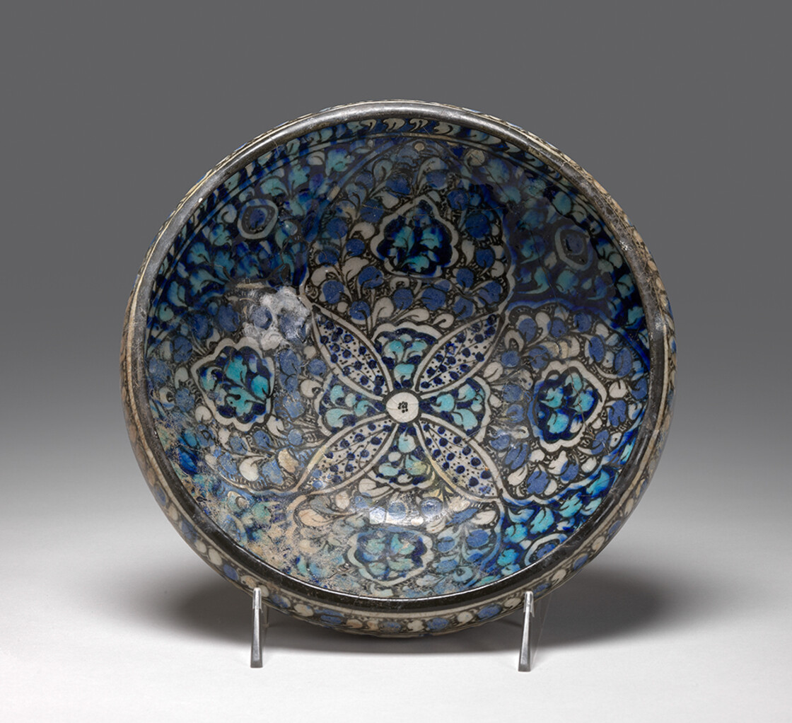 Bowl, T section rim, blue with four-petal flower in interior