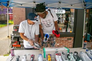 Paper City Clothing Company co-owner Fernando Goffe compares Air Jordans with Jizay?s Clothing Store owner Jay Alvarado, during the Sneaker Mixer event hosted by Paper City Clothing Company, Saturday in Holyoke, MA.