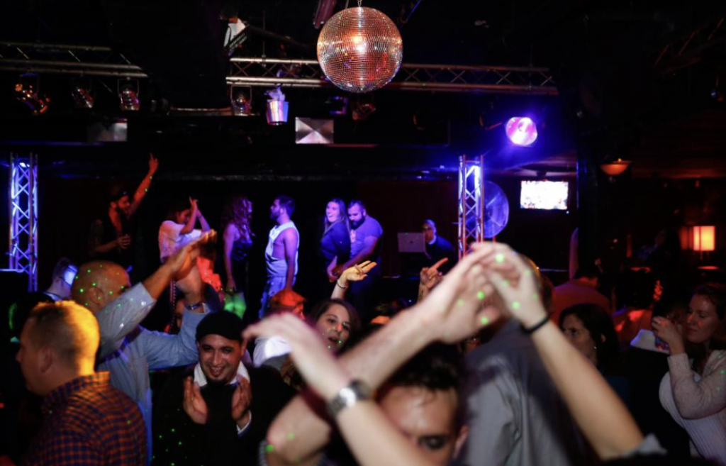 People dancing at Diva’s nightclub on a Saturday night in Northampton, MA.