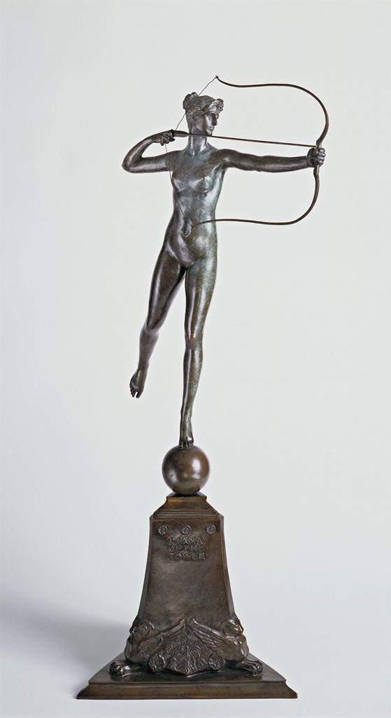 A metal sculpture of a woman holding a bow and arrow, while balancing on one foot.