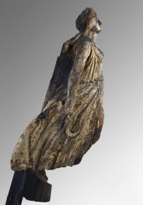 Wooden statue of a woman that would have been attached to the bow of a ship.