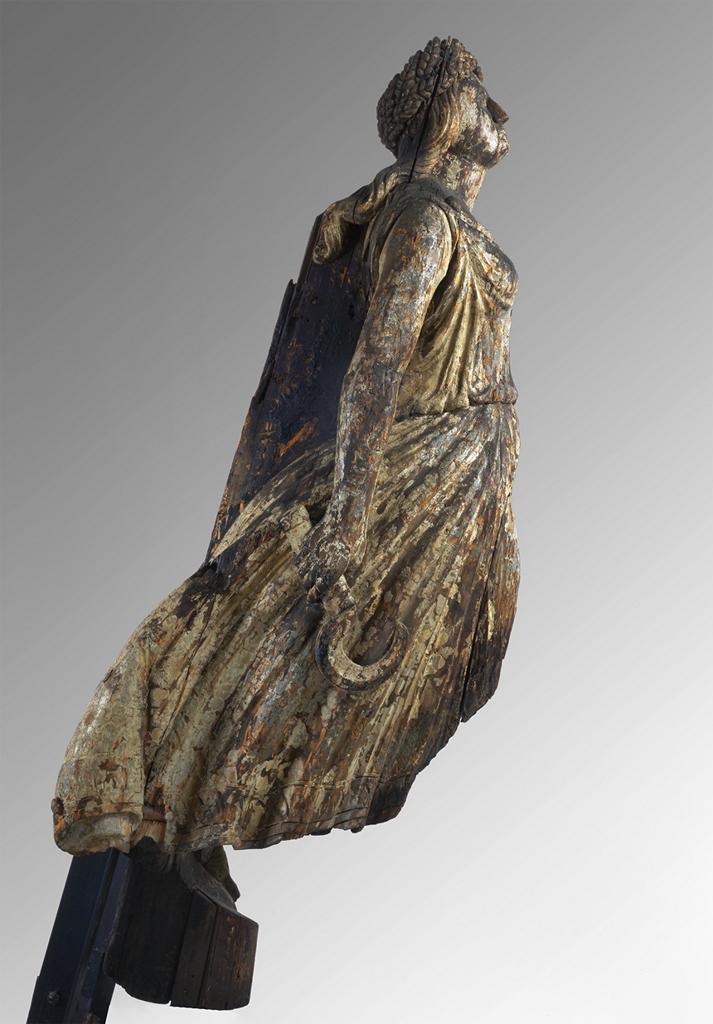 Wooden statue of a woman that would have been attached to the bow of a ship.
