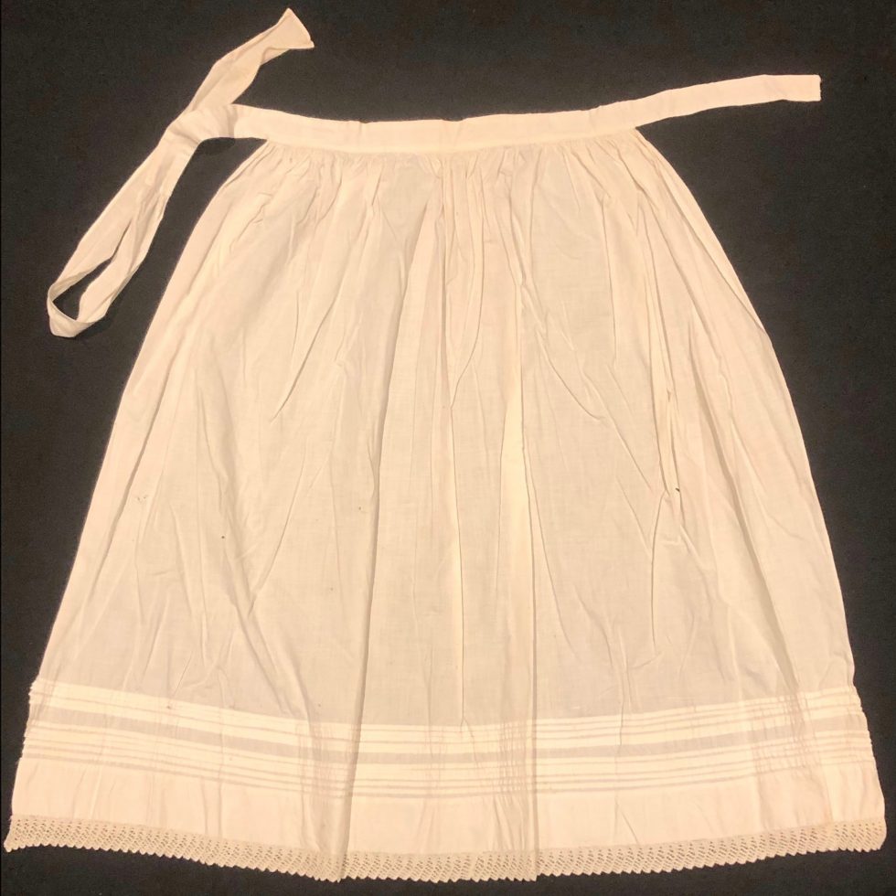 White Apron with pleated detail.
