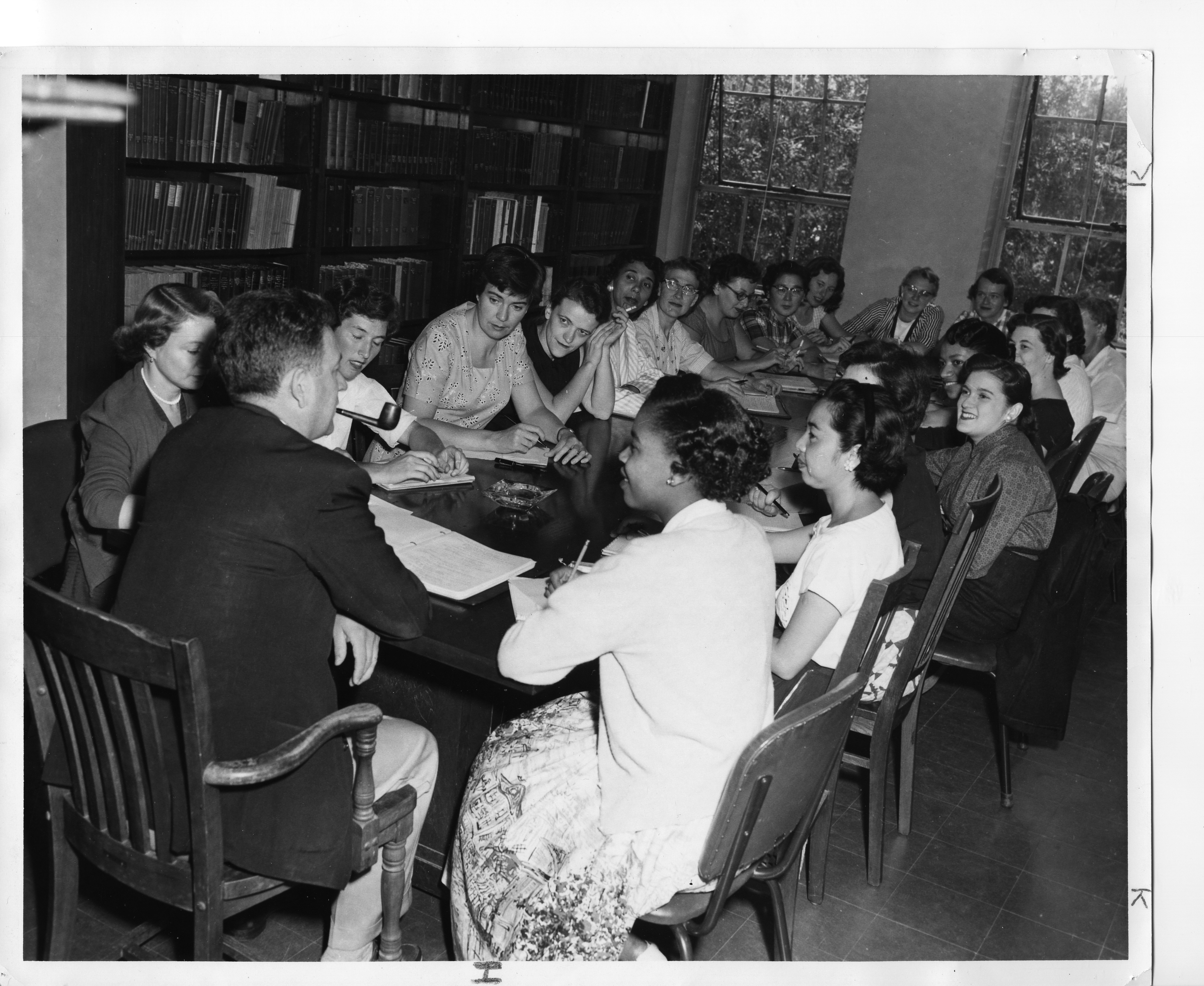 Black and white photo of a group of people seated at a table.