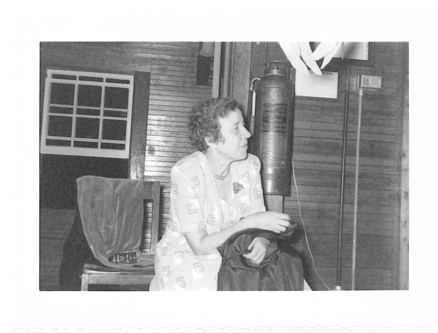 Black and white photo of Annette Garrette at an indoor party.
