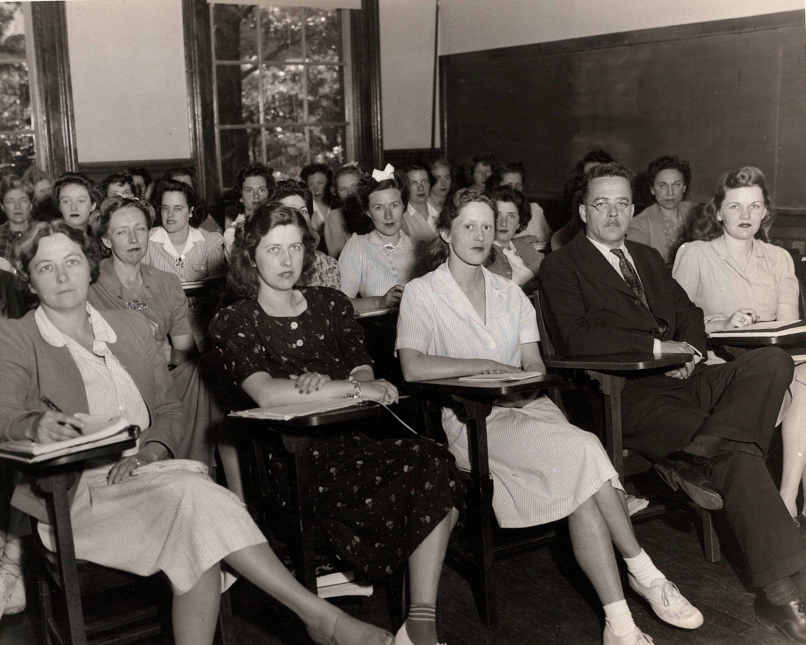 Black and White photo of SSW students at desks facing forward.