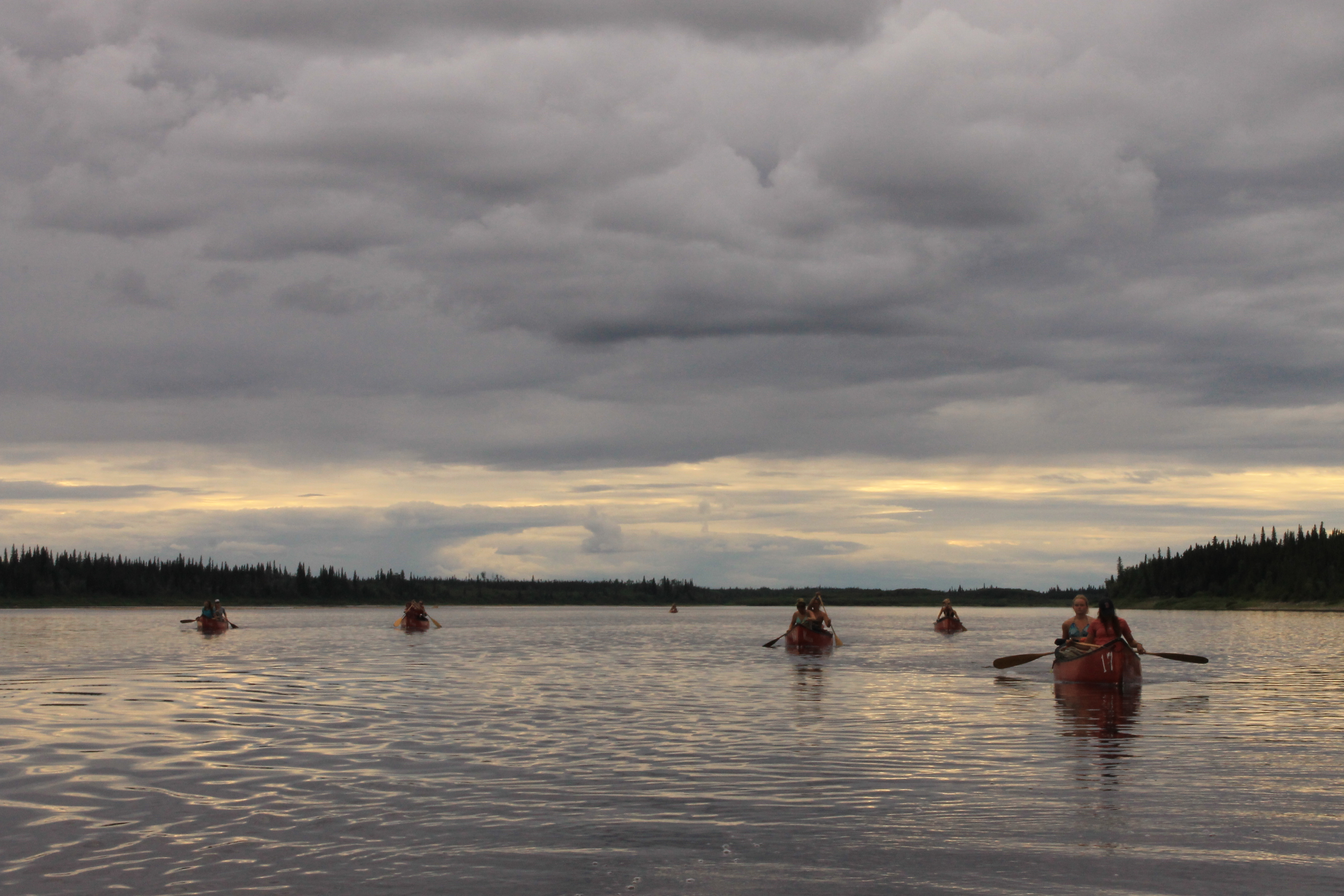 Canoeists paddling on a lake.