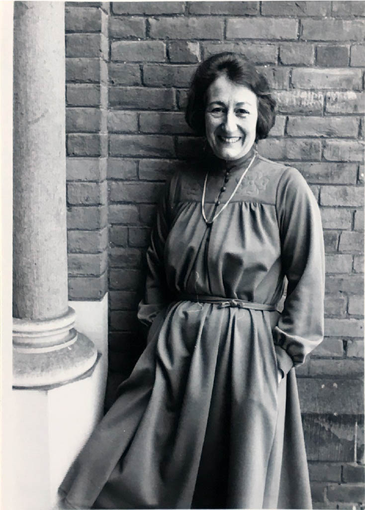 Portrait of Eleanor Rothman, director of the Ada Comstock Scholars Program, standing against a brick wall.